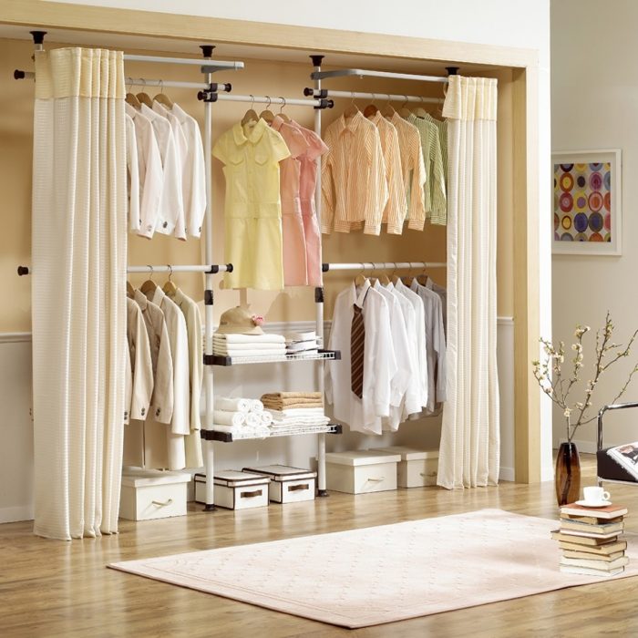 Furniture + Accessories Medium size Spacious Closet Style Tool Escorted By Beige Room Colouring Nice Beige Metal Framed Cloth Rack Escorted By Wooden Trimming Nice White Rug On The Beige Wooden Floor Also Ice Small