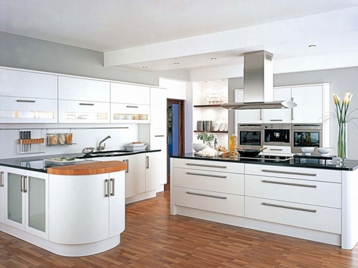 Kitchen Designs Interesting Solid White Kitchen Cabinet Scheme Style Escorted By Black Marble Top Also Modern Touch Sink Incredible L Shapw White Wooden Cabinetry See Kitchen Island Styles Over The Sink Lighting for Kitchen Lighting Fixtures