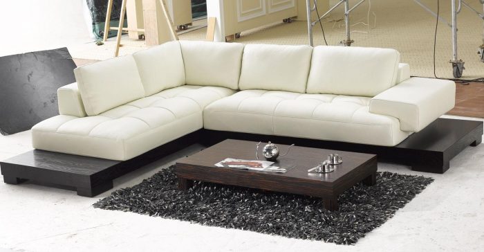 Furniture + Accessories Medium size Modern Leather Sectional White Sofa And Stained Wooden Table With Glass And Magazines Black Fur Rug White Floor Ideas And Several Furniture For Interior Home
