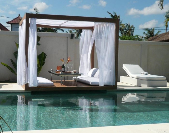 Furniture + Accessories Medium size Romantic Outdoor Canopy Bed Escorted By Wooden Floor Also White Sofas Beds Also Coffee Tables Glass Top Which Is Located Above The Pool Awesome Outdoor Beds Escorted By Canopy Style