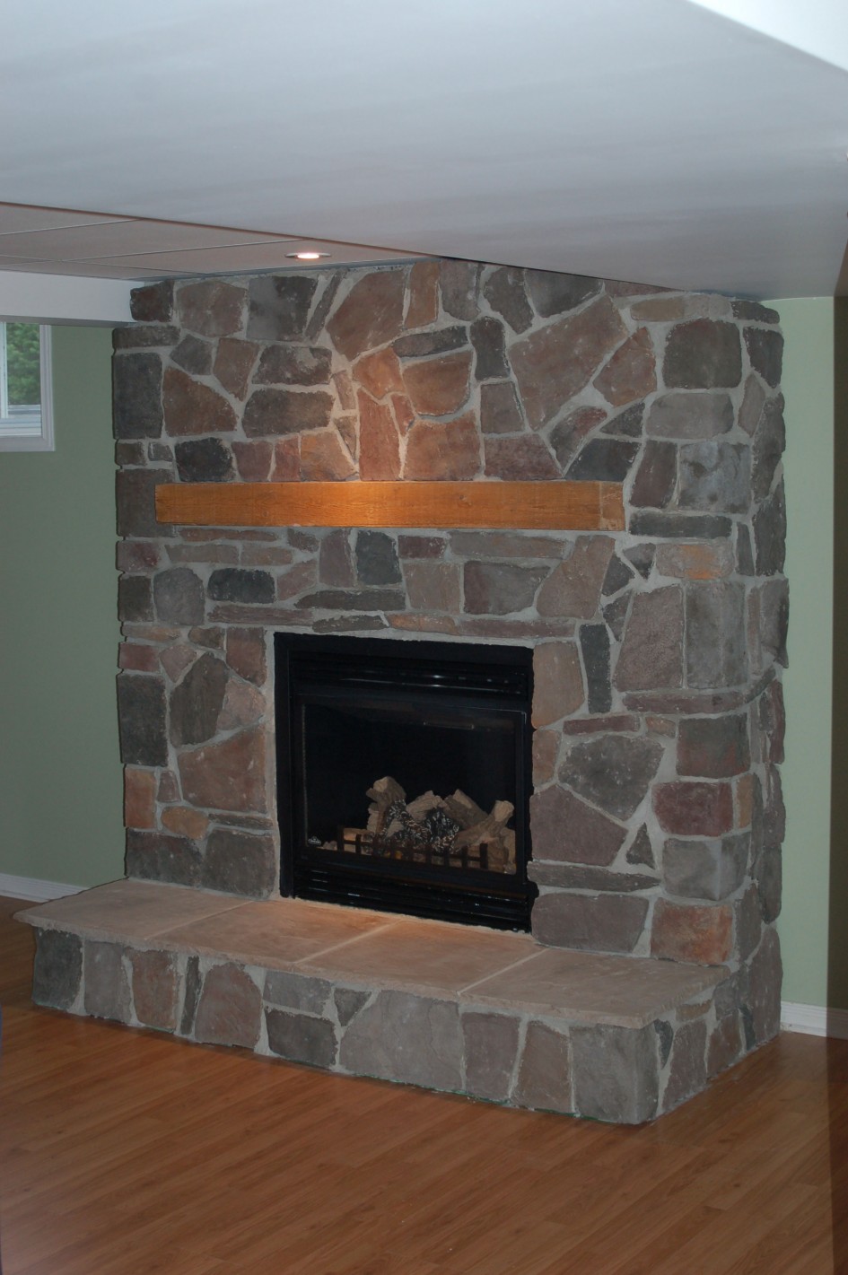 Cool Livingroom Decoration Escorted By Corner Stone Fireplace Nice River Rock Also Golden Honey Wood Walling Black Glass Fire Place Escorted By Elegant Handle Corner Stone Fireplace For Beautiful Kitchen Designs