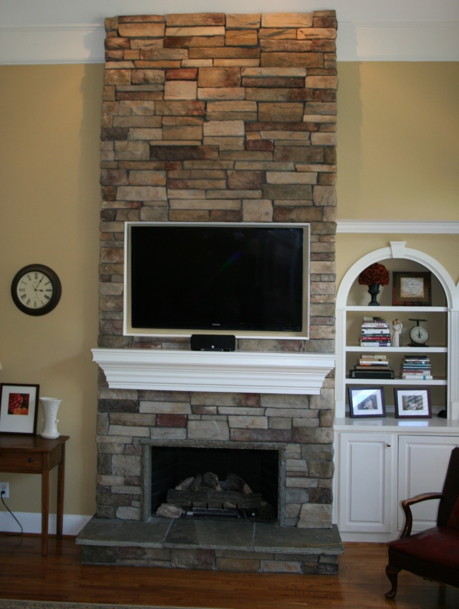 Corner Stone Fireplace Escorted By River Rock Walling Cool Gypsum Wall Tv Shelves In White Colour Intimating Woden Cabinet Escorted By Book Shleves Corner Stone Fireplace For Beautiful Livingroom Kitchen Designs