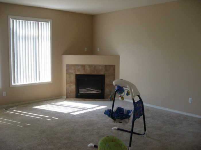 Kitchen Designs Elegant Corner Stone Fireplace Escorted By Beige Fireplace Trimming Nice Window Escorted By Transparent Curtain Natural Florring Colour Corner Stone Fireplace For Beautiful Livingroom Stones for Fireplace: Various Designs of Fireplaces