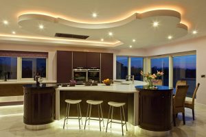 Kitchen Designs Thumbnail size Cool White Kitchen Countertop Wall Glass Window Rattan Chair Bar Stool Glass Wine Purple Teapots Stainless Faucet Oven Wall Brown Kitchen Island Kitchen Cabinet Ceramic Floor Small Lamp Fruits