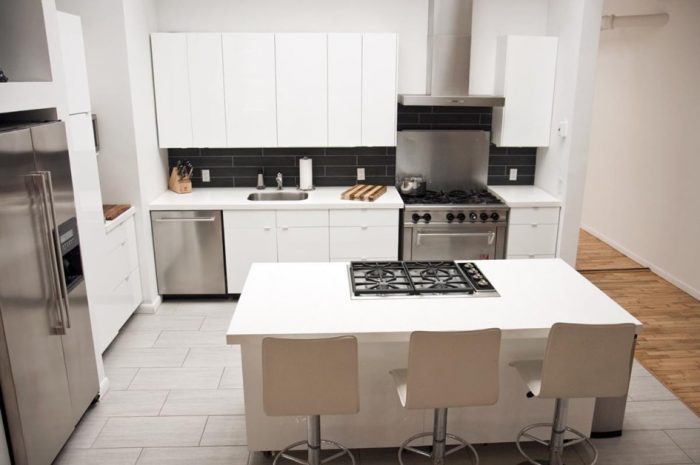 Kitchen Designs Minimalist Kitchen Design Ideas With White Kitchen Units Design And Stainless Range Hood Also White Kitchen Island Design With Stove And Seating And Grey Ceramic Tile Floor Design Options For Countertops: Glass Or Solid Surface