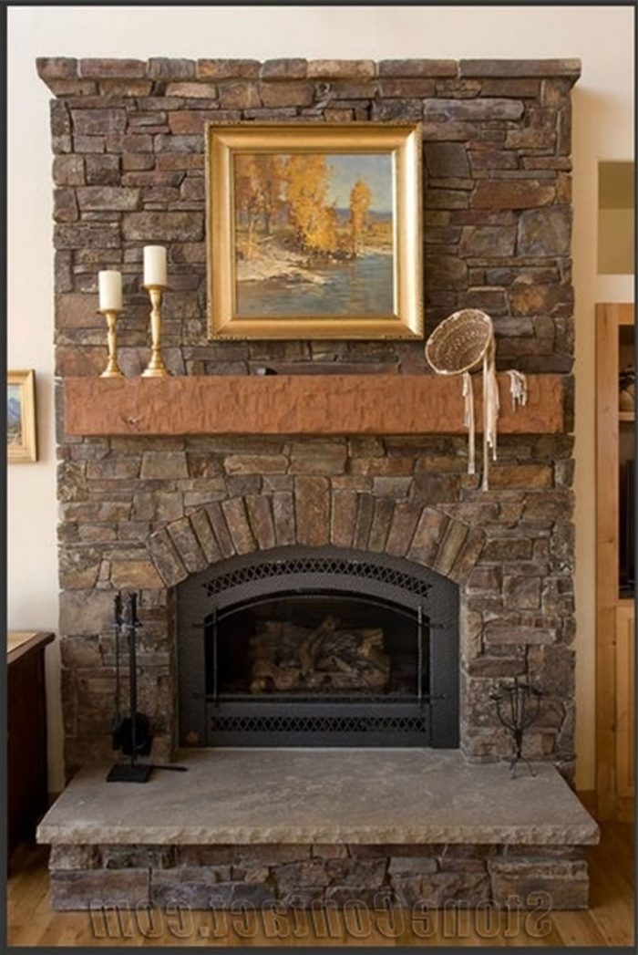 Living Room Designs Gold Framed Painting Also Chic Candleholders Above The Fireplace Delivering A Cool Look On How To Decorate A Stone Fireplace Also Style Scheme Stone Fireplaces For Modern And Minimalist Houses